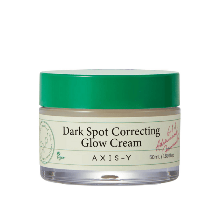 Pohár "AXIS-Y Dark Spot Correcting Glow Cream". Tento krém je určený na korekciu tmavých škvŕn a dodanie pleti žiarivosti. Balenie je elegantné s priehľadným dnom a nápadným zeleným viečkom.