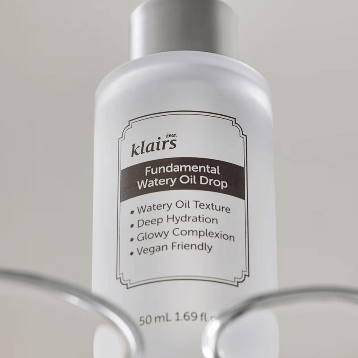 Fľaša s Klairs Fundamental Watery Oil Drop, 50 ml, umiestnená v priehľadnom držiaku, s jasnou etiketou, ktorá vyzdvihuje hydratačné a vegánske vlastnosti produktu.