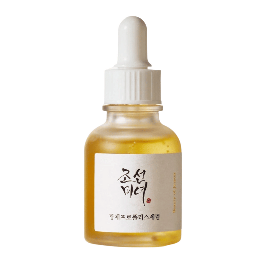Flaska av Beauty of Joseon Glow Serum med vit pipett och guldfärgat serum, en lystergivande produkt med propolis och niacinamid.