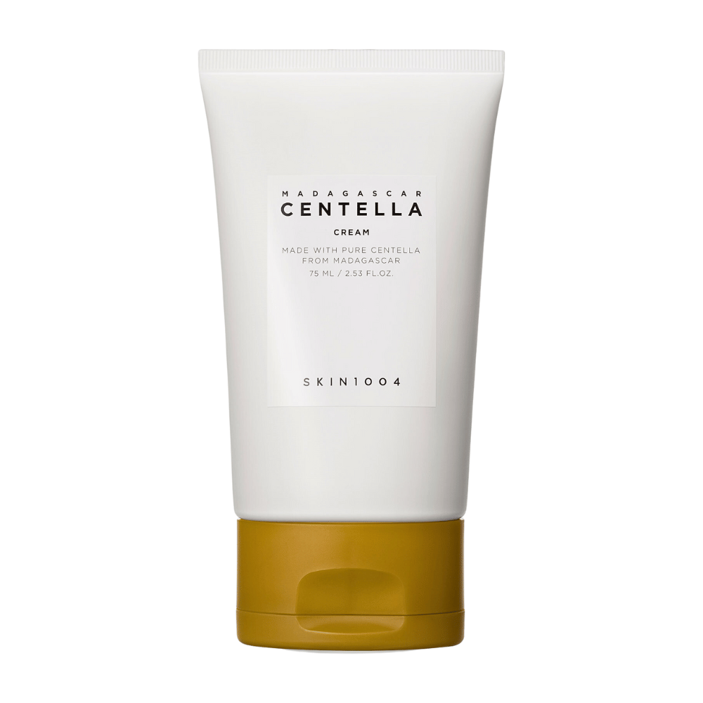 Obrázok zobrazuje tubu s "Madagascar Centella Cream" od SKIN1004. Je to krém na pleť vyrobený z čistej Centelly z Madagaskaru a je balený v balení o veľkosti 75 ml / 2.53 fl.oz. Produkt je určený na starostlivosť o pleť, aby poskytoval výživu a hydratáciu pokožke.