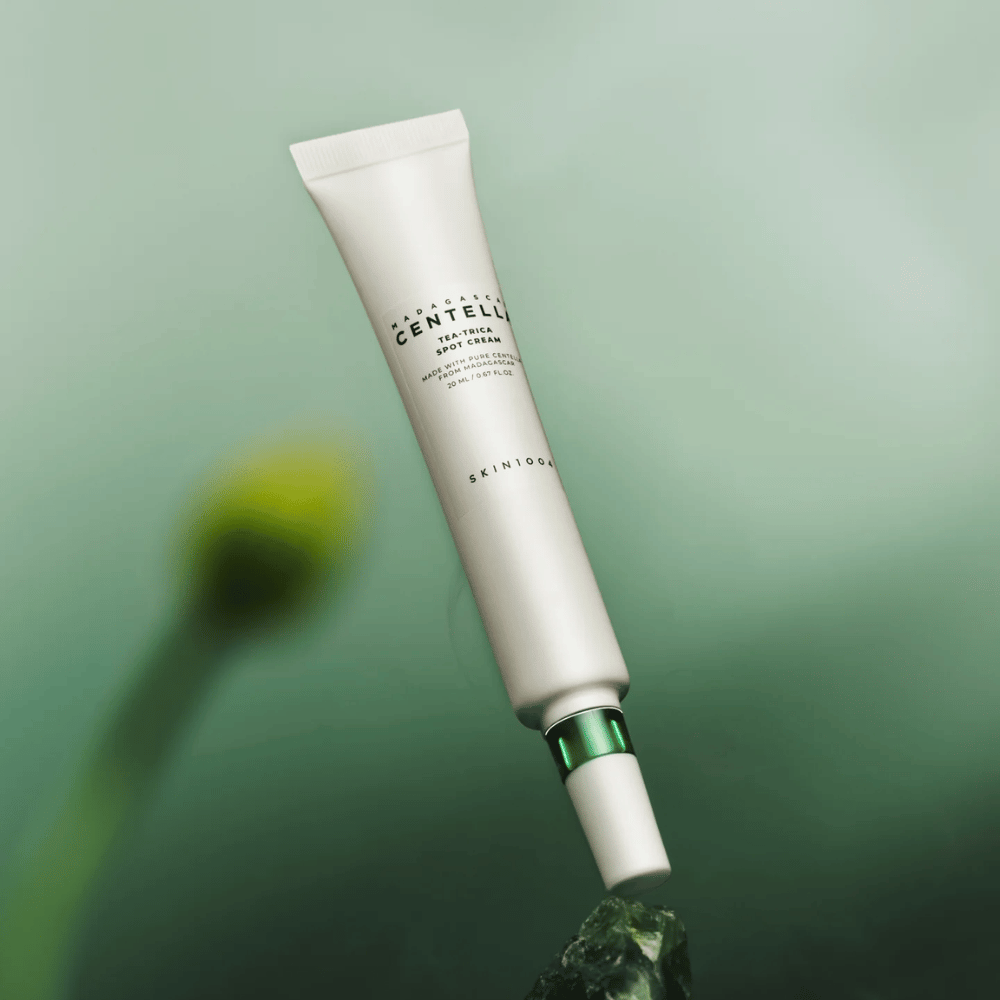 SKIN1004 Madagascar Centella Tea-Trica Spot Cream vznášajúci sa na zelenom pozadí – účinný spot treatment pre pleť náchylnú na akné s centellou z Madagaskaru.