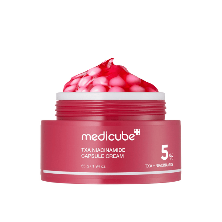 Medicube TXA Niacinamide Capsule Cream v nádobe s ružovými kapsulami v gélovej forme, s viditeľným označením produktu s 5 % TXA + Niacinamide.